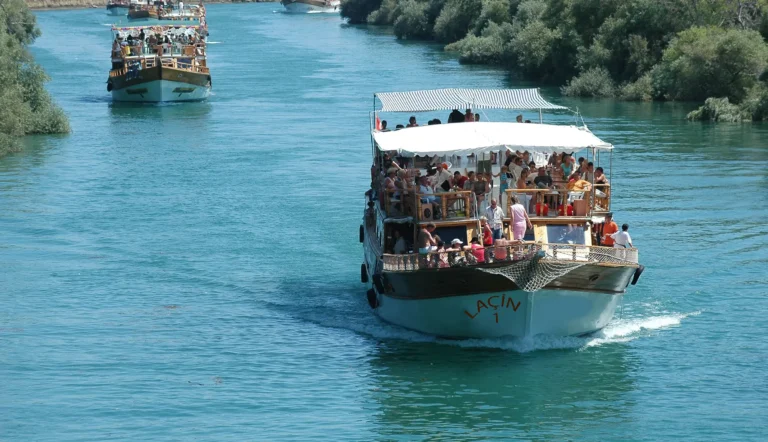Guests ride a shaded excursion boat down the Manavgat River during the boat tour