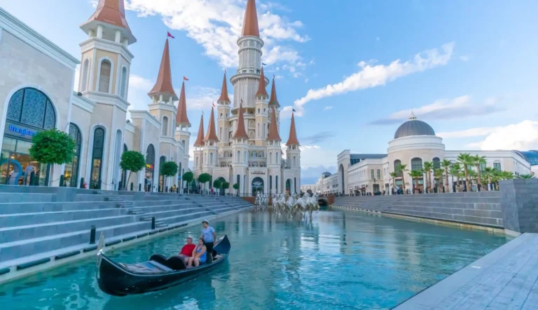 Guests ride a gondola along the canal in front of the castle at The Land of Legends