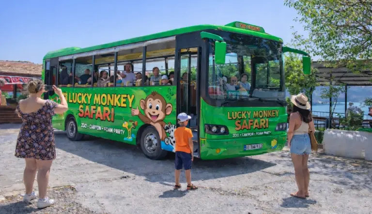 Tour guests boarding the Lucky Monkey Safari bus on the zoo park excursion from Side